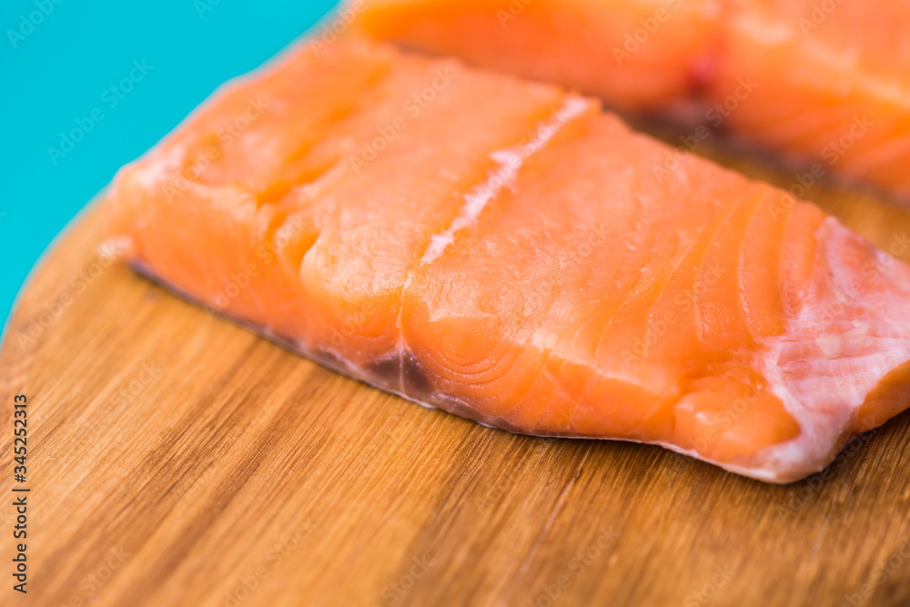 Fresh raw salmon on wooden cutting board.