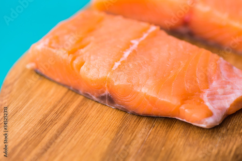 Fresh raw salmon on wooden cutting board.