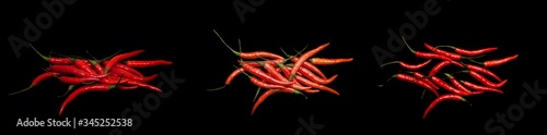 Red chili pepper isolated on a black background.