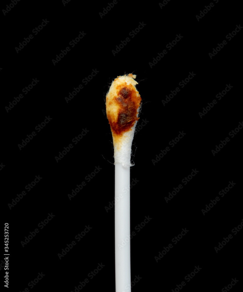 Ear sticks are dirty on a black background.