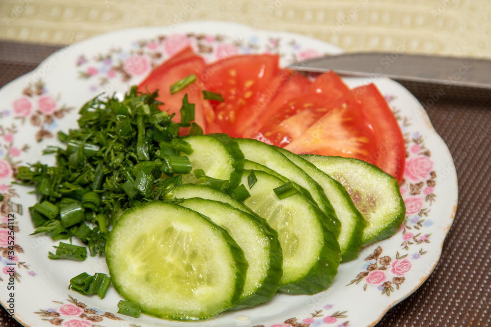 Cucumber and tomato salad on a plate. Cucumber and tomato salad on a plate.