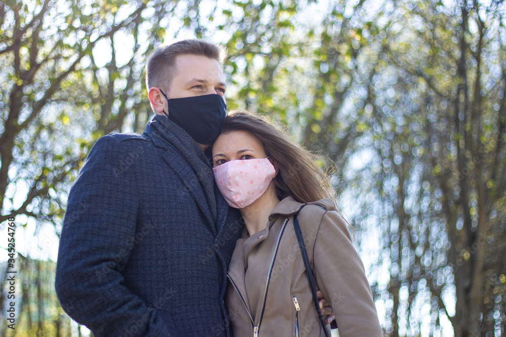 Masked young couple walking in the park Masked young couple walking in the park