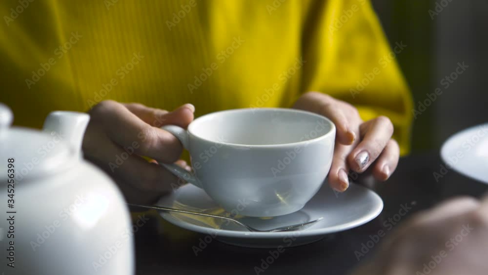 Close-up of man and woman talking over tea. Stock footage. Man gestures with hands while talking to woman over tea or coffee