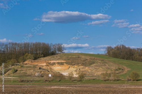green hill on brown earth and blue sky © Александр Варуха