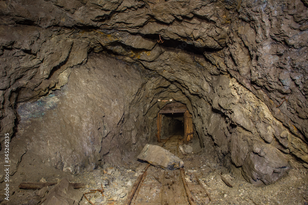 Underground old abandoned iron mine tunnel with doors Underground old abandoned iron mine tunnel with doors