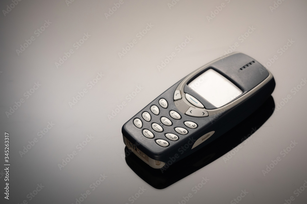 An outdated mobile phone with a screen for copying space on a gray gradient background. The minimalist trend. smartphone. with copy space for text. An outdated mobile phone with a screen for copying space on a gray gradient background. The minimalist trend. smartphone. with copy space for text.