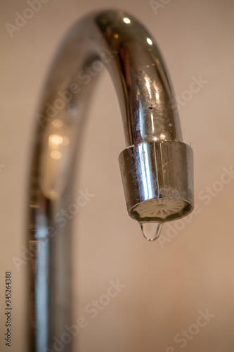 Dripping chrome tap letting water leak out