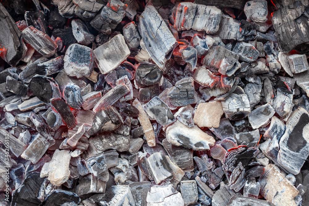 Burning coals in the grill, close up, background, top view Burning coals in the grill, close up, background, top view