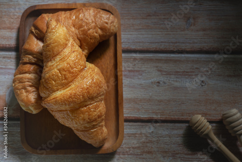 Tasty buttery croissants on  wooden table