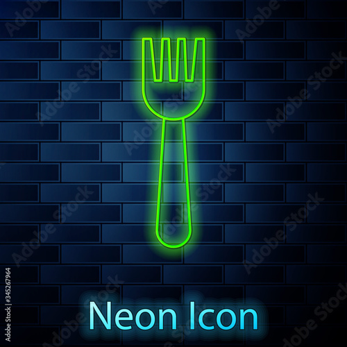 Glowing neon line Disposable plastic fork icon isolated on brick wall background.  Vector Illustration