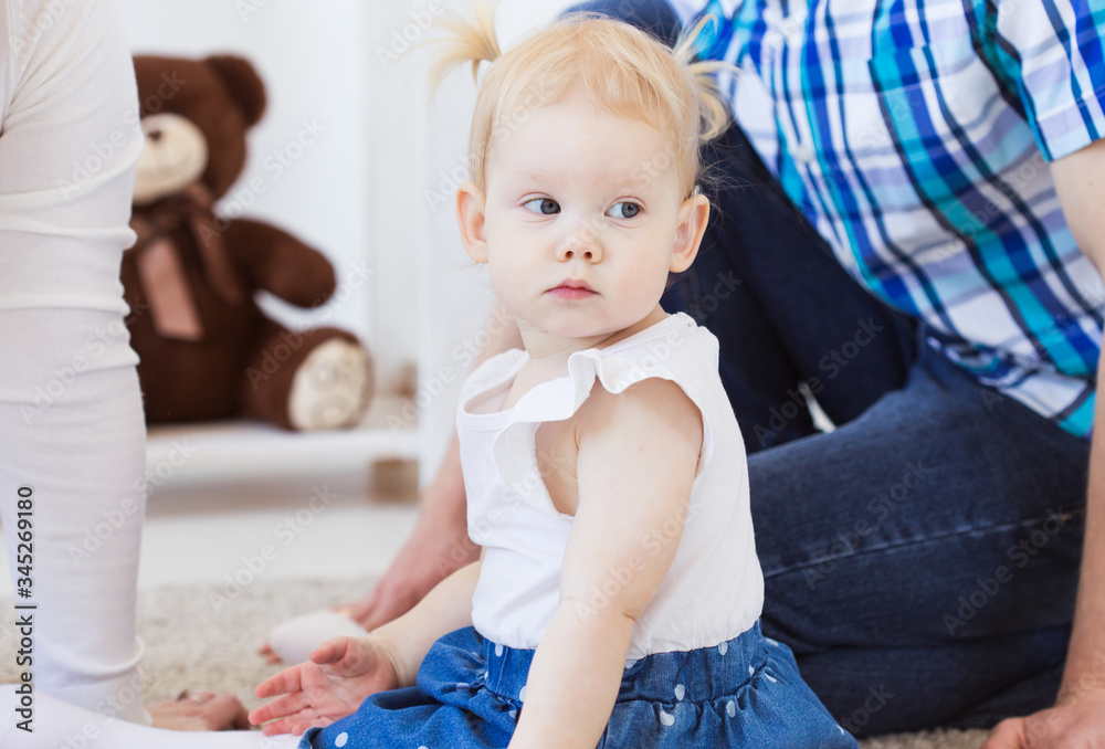 Fototapeta premium Baby girl wearing a hearing aid. Disabled child, disability and deafness concept.