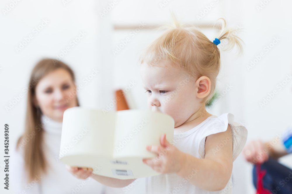 Cute baby girl playing indoors. Childhood, infant and children concept. Cute baby girl playing indoors. Childhood, infant and children concept.