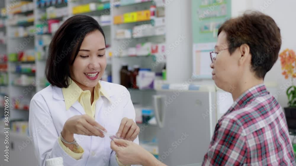 asian female pharmacist and patients talking and smiling detail medicine in pharmacy store Thailand asian female pharmacist and patients talking and smiling detail medicine in pharmacy store Thailand