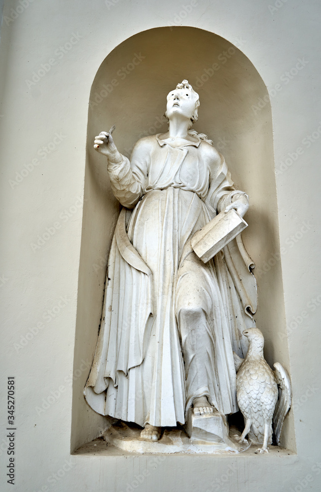 Dusty statue of virgin Mary near the entrance to the church Dusty statue of virgin Mary near the entrance to the church