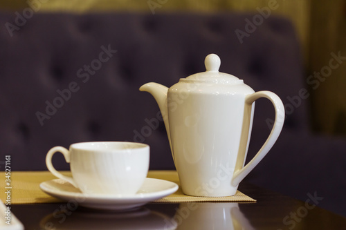 Tea cup and tea pot on table. Breakfast and Five O'Clock Tea. Tea time.
