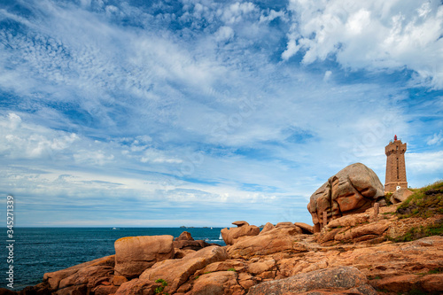 Ploumanac'h Mean Ruz lighthouse between the rocks in pink granite coast, Perros Guirec, Brittany, France.