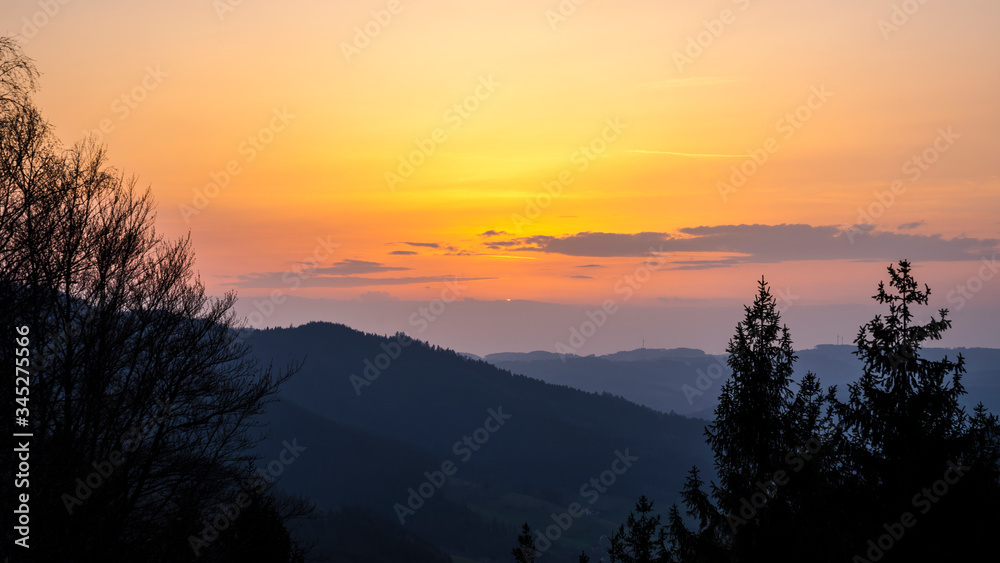 Germany, Romantic orange black forest nature landscape sunset sky view after sunset from above with silhouette like mountains