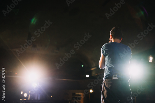 back of a man on the stage from behind
