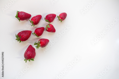 Flat lay composition with with tasty ripe strawberries on light background