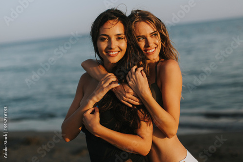 Young women having fun at summer vacations on the beach