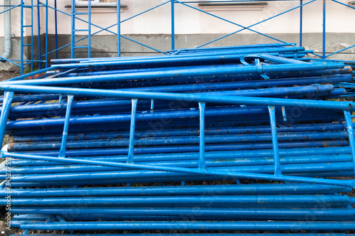 blue metal scaffolding stacked before installation