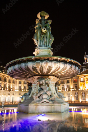 Statue fountain of three graces on the place de la bourse in Bordeaux city at night in Gironde New Aquitaine France