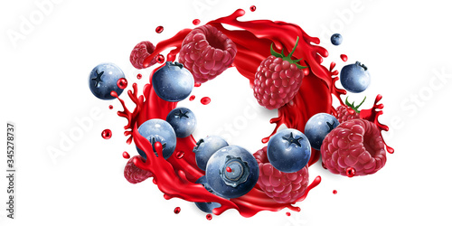 Composition of blueberries and raspberries in a juice splash.