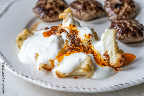 Healthy Organic Vegetarian Cauliflower with Yogurt, Fried Butter Sauce and Turkish Style Meatballs Kofte or Kofta / Yoghurt.