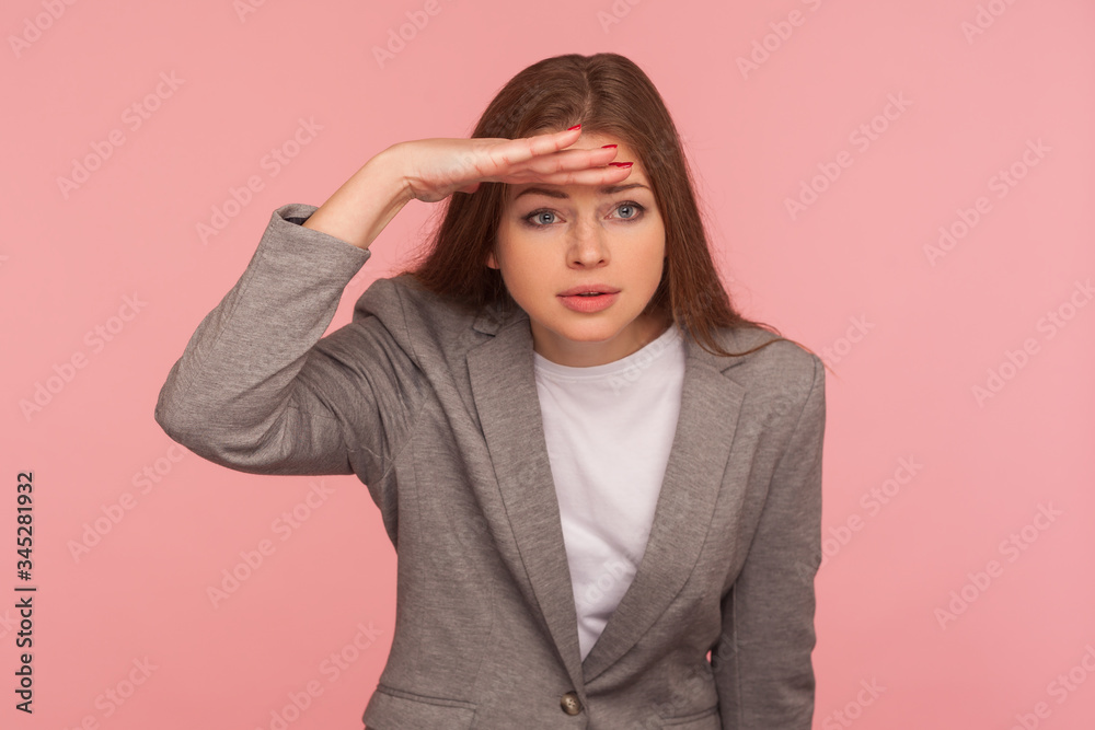 Portrait of pretty young woman in business suit holding hand over eyes and looking far away with attentive view, being ambitious making business plans for successful future. studio shot isolated Portrait of pretty young woman in business suit holding hand over eyes and looking far away with attentive view, being ambitious making business plans for successful future. studio shot isolated