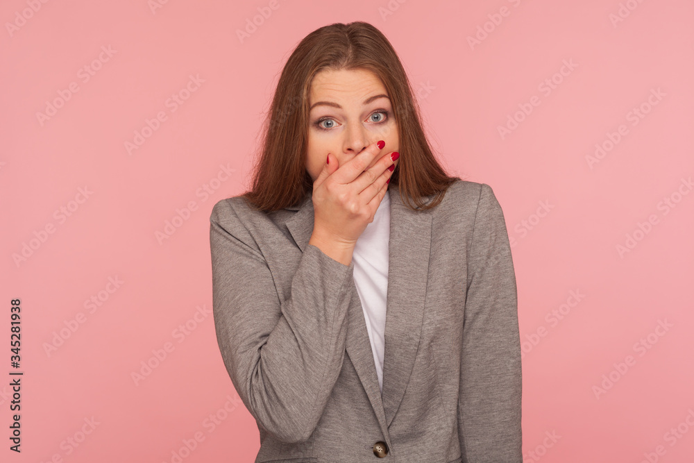 I won't tell anyone! Portrait of frightened intimidated woman in business suit keeping her mouth closed with hand, wondered about secret, terrified to speak. studio shot isolated on pink background I won't tell anyone! Portrait of frightened intimidated woman in business suit keeping her mouth closed with hand, wondered about secret, terrified to speak. studio shot isolated on pink background