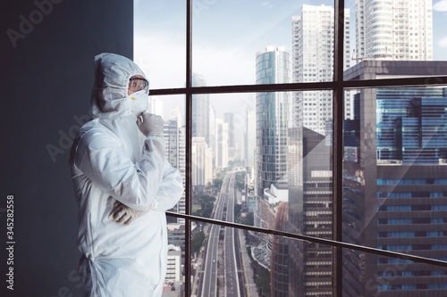 Man in hazmat daydreaming near the city scenery