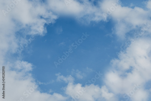 Background blue sky and white clouds around. Photo with copy space.