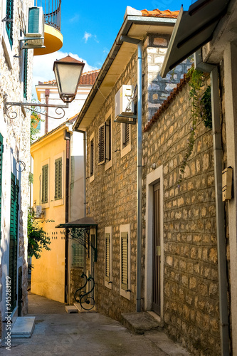 Winding street of the authentic, old town of Herceg Novi, Montenegro. We see old houses and very narrow