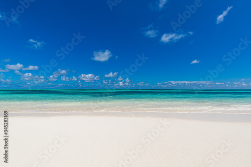 Empty tropical beach landscape. Paradise island concept, beach minimal, blue sky over white sand at exotic coastline or shoreline. Summer scenery, vacation landscape. Nature sea ocean view