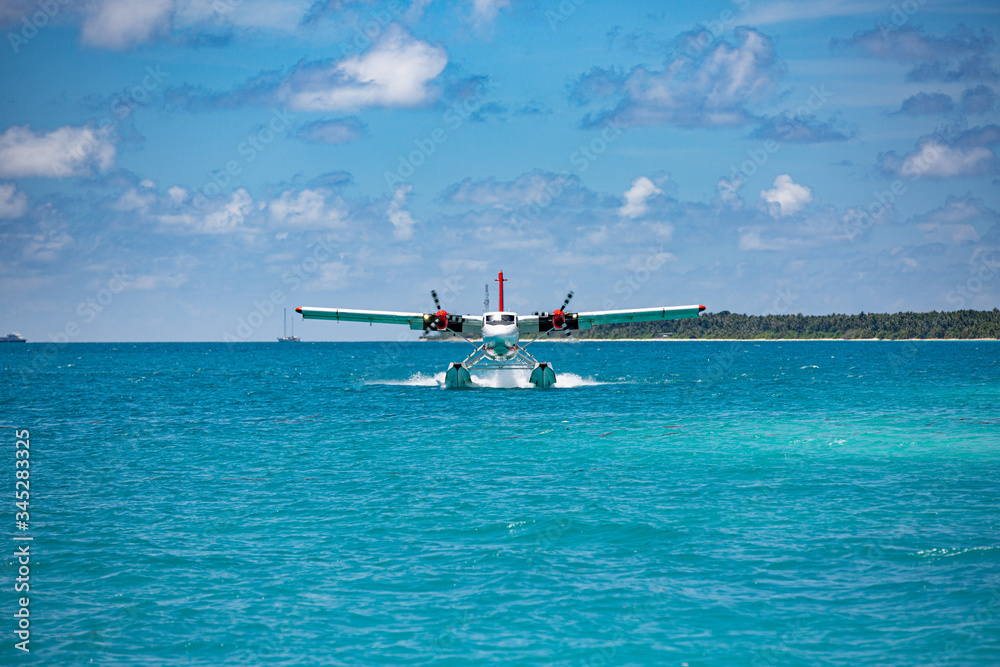 Sea plane at tropical beach resort. Luxury summer travel destination with seaplane in Maldives islands. Exotic vacation or holiday transportation, Maldives sea Sea plane at tropical beach resort. Luxury summer travel destination with seaplane in Maldives islands. Exotic vacation or holiday transportation, Maldives sea