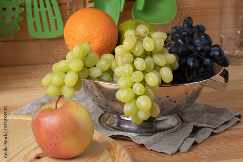 Fresh fruits on a wooden background  cutting wooden board and knife