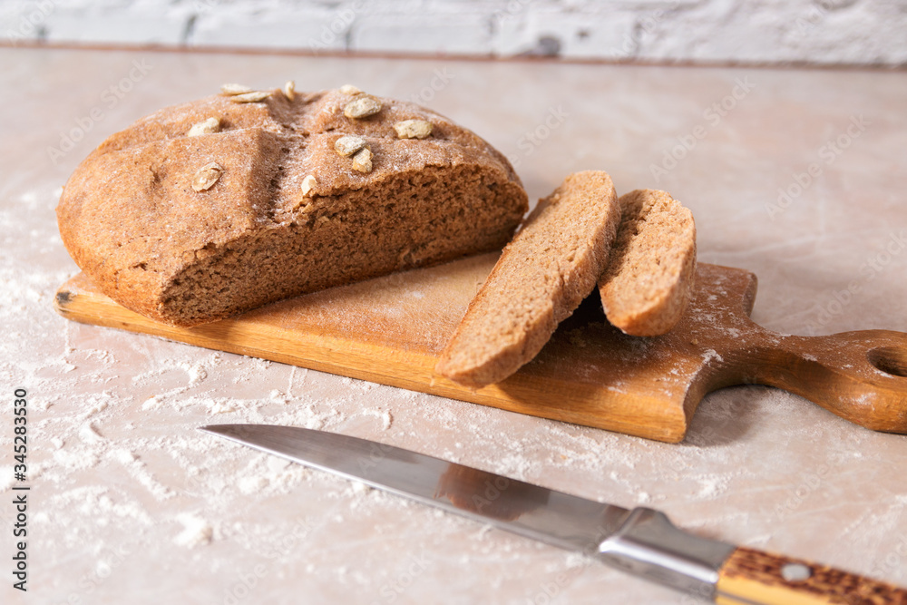 fresh healthy home baked bread with pumpkin seeds sliced on wooden board