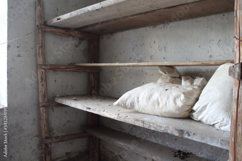 wooden shelves with white bags