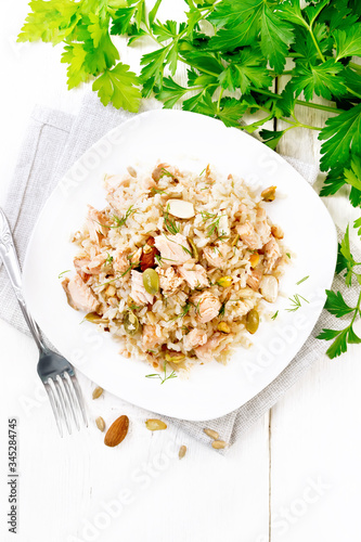 Salad of salmon and rice in plate on light board top