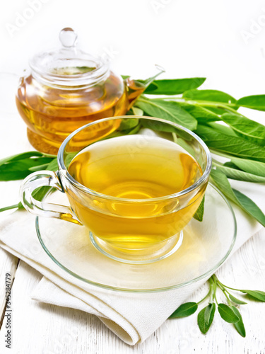 Tea herbal with sage in cup on wooden board