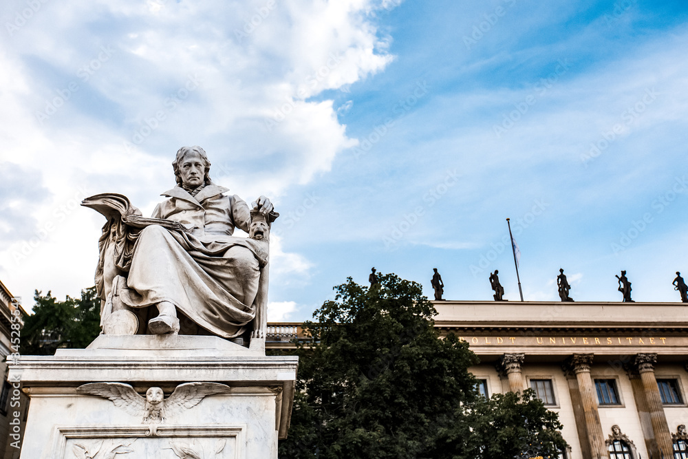 Obraz premium White statue near Humboldt University in Berlin, Europe. Monument against blue sky with white clouds