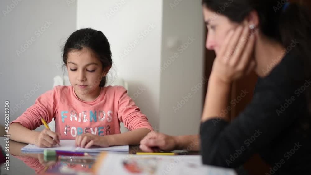 Mother and daughter doing homework at home and having discussion Mother and daughter doing homework at home and having discussion