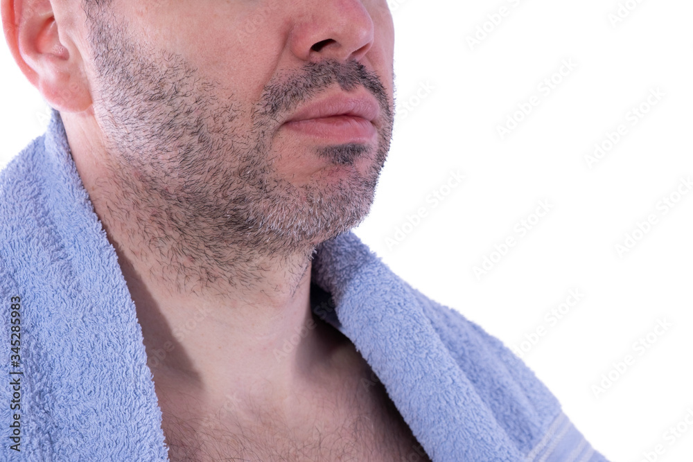 Obraz premium male face with bristles and a towel on his shoulders, side view