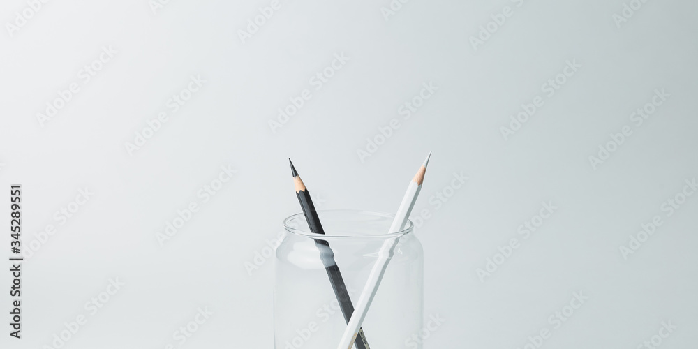 Black and white pencils in a glass jar to show each other friendship and respect.Different but together.Against racism concept