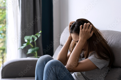 Photography Lonely young asian woman felling depressed and stressed in living room at home,
