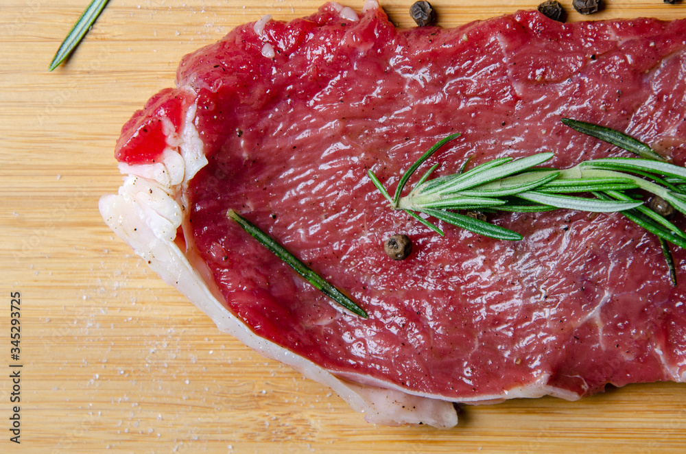 steak, rosemary and salt on a serving board steak, rosemary and salt on a serving board