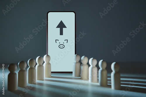 Online banking service. Forex trading. E-banking app. Arrow up, piggy-bank signs on smartphone screen, wooden figures photo