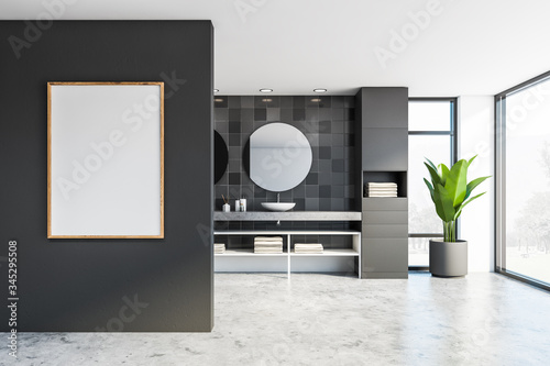 Double sink and poster in gray tile bathroom