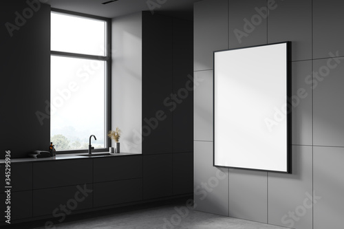 Dark grey bathroom with sink and poster