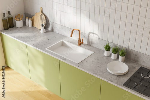 Green countertops in white kitchen, top view photo